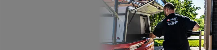 Hicklin Omaha garage door installer putting hardware in his service truck